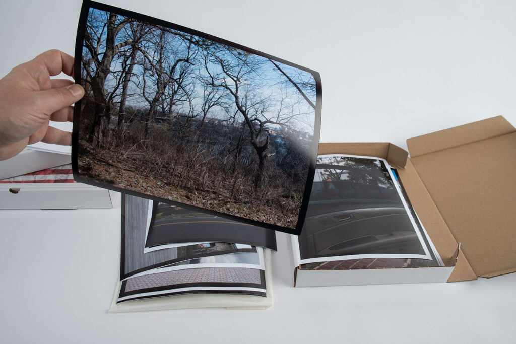 Ansicht der 10er-Edition der künstlerischen Arbeit „That’s Life?“. Der bedruckte Karton besitzt die Außenmaße von 34 cm x 24 cm. Im Karton befinden sich die 22 Motive der Serie. Jeder Abzug besitzt die Größe von 24 cm x 32 cm. Hinzu kommt noch ein Künstler Kommentar zur Arbeit, gedruckt und signiert.